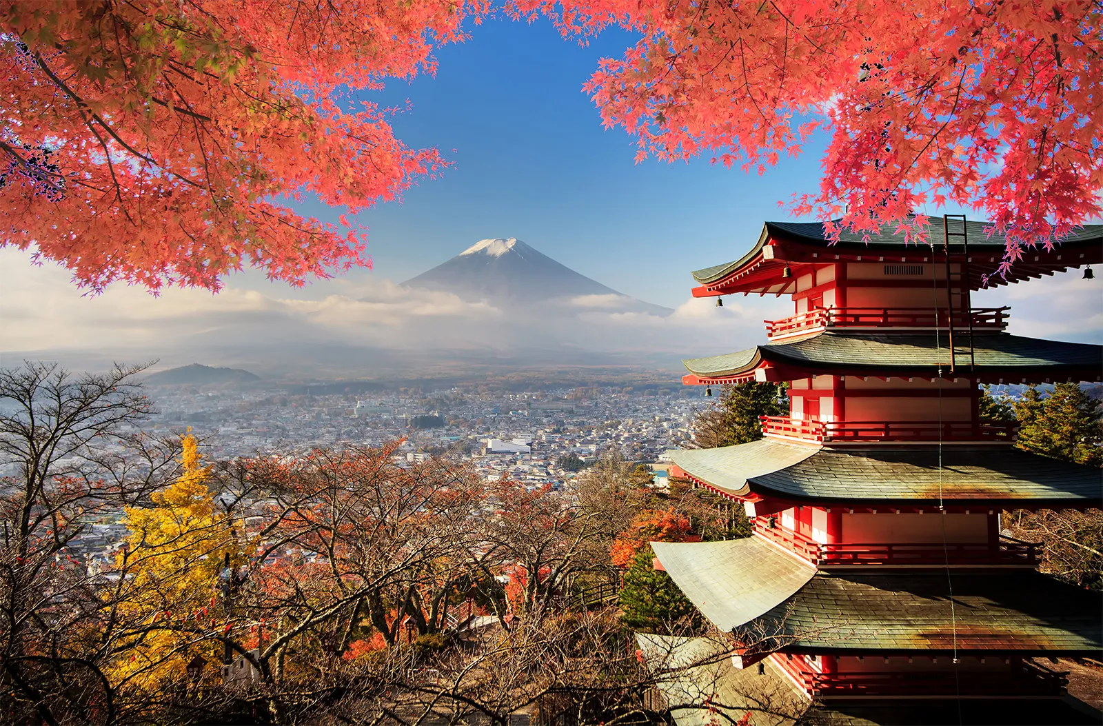 A red pagoda in front of Mount Fuji