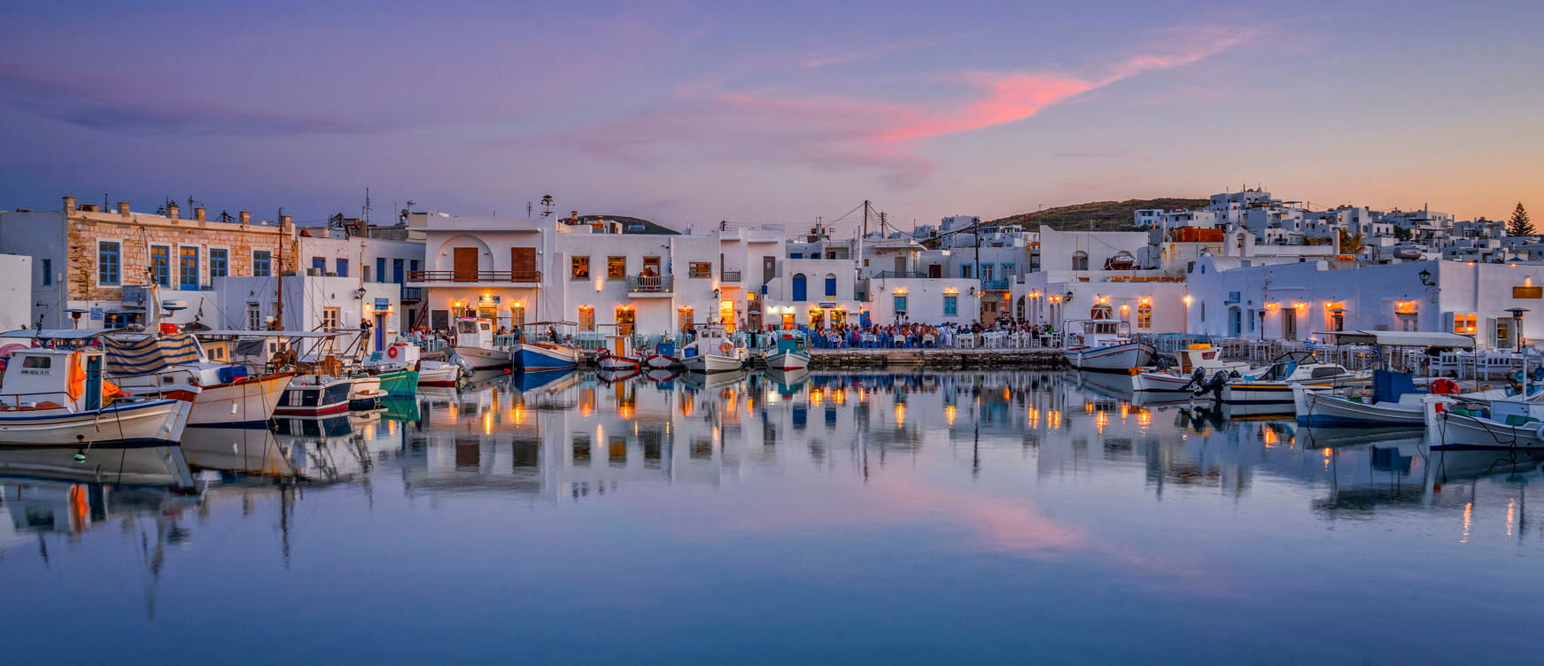 Boats parked at a marina in Paros