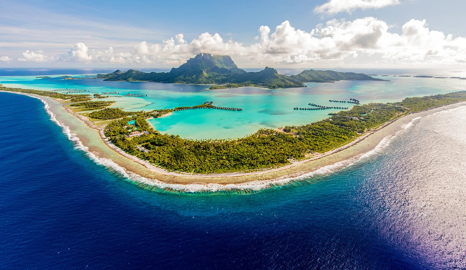 Beautiful blue ocean surrounding the lush green island of Bora Bora