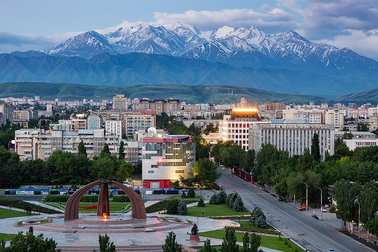 Bishkek City, tall buildings in front of massive mountains
